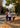 Couple walking their dog on a fall day, using a hands-free belt and leash for a comfortable, effortless stroll.