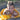 Smiling boy cuddling his fluffy dog wrapped in a bright yellow towel after swimming, showing warmth and companionship outdoors.