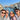 Glowhound founders smiling on a Venice canal bridge with scenic waterway, historic buildings, and boats in the background.