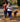 Couple walking their dog on a quiet autumn street using a hands-free dog leash for convenience.